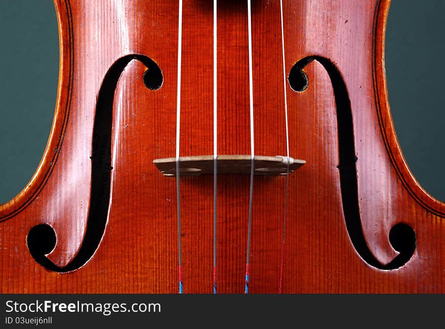 Antique violin close-up showing f-holes, sound-holes, approximately 80 years old