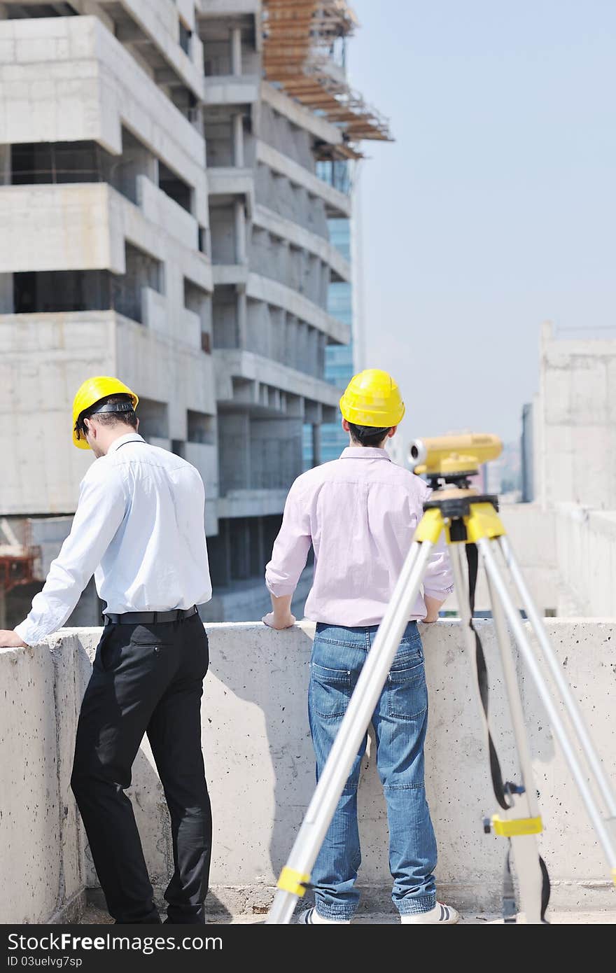 Team of business people in group, architect and engeneer on construciton site check documents and business workflow on new building. Team of business people in group, architect and engeneer on construciton site check documents and business workflow on new building