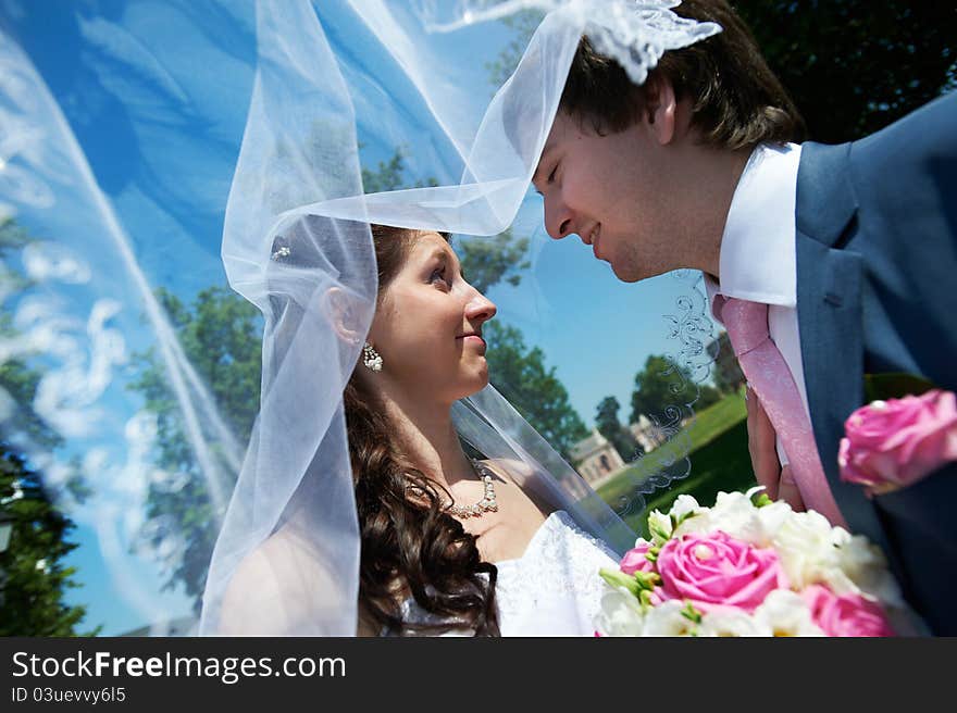 Happy bride and groom in park