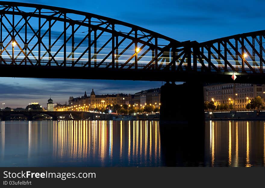 Railroad bridge over the river in the city after sunset. Railroad bridge over the river in the city after sunset