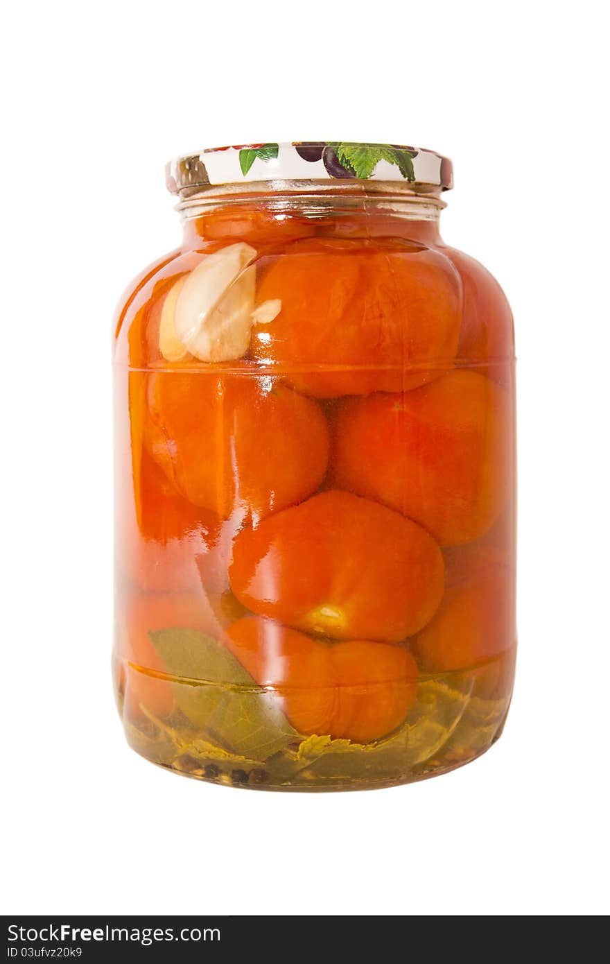 Marinated tomatoes in a glass jar isolated on white background