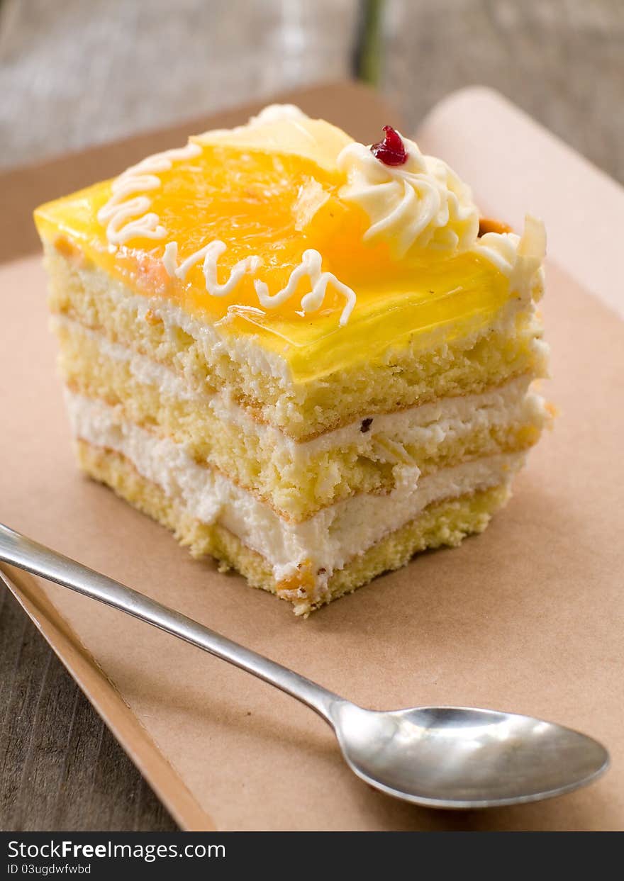 A piece of cheese torte on a paper plate. Selective focus. A piece of cheese torte on a paper plate. Selective focus