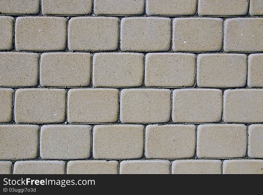 Path background fragment. Path made of small grey bricks.