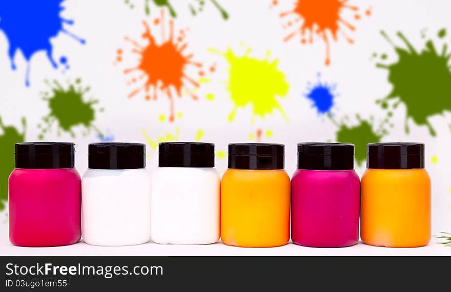 Coloured paint boxes, scattered on the floor with splash paint. Coloured paint boxes, scattered on the floor with splash paint