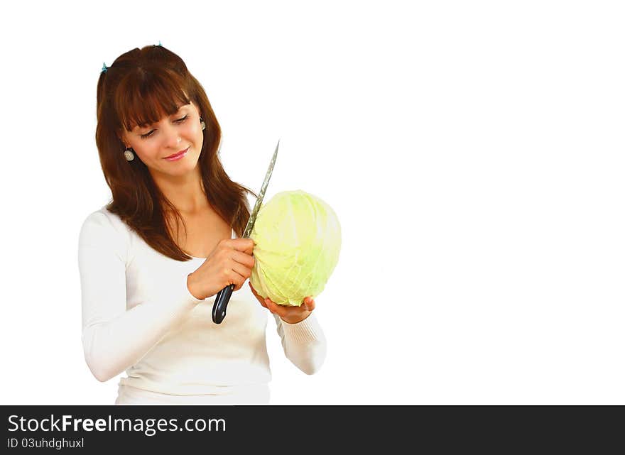 A woman cutting a green cabbage isolated on a white background. A woman cutting a green cabbage isolated on a white background