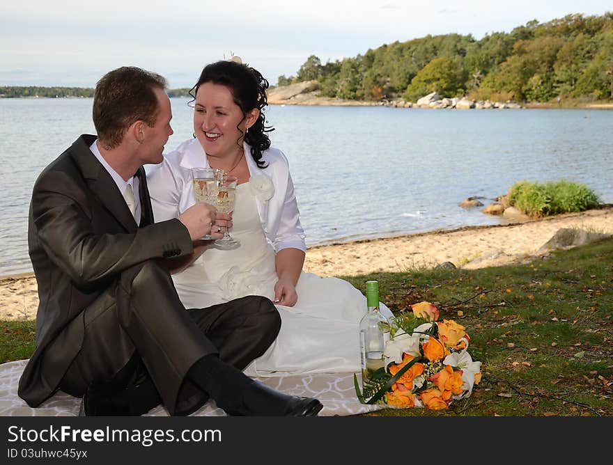 Newlyweds drinking wine outdoor