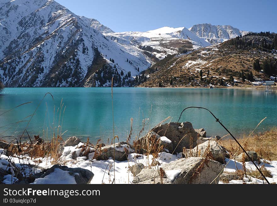 Beautiful glacier Big Almaty lake surrounded by snowcovered peaks in Tien Shan Alatau mountains, Kazakhstan Central Asia. Beautiful glacier Big Almaty lake surrounded by snowcovered peaks in Tien Shan Alatau mountains, Kazakhstan Central Asia