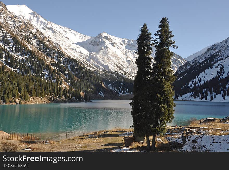 Beautiful glacier Big Almaty lake surrounded by snowcovered peaks in Tien Shan Alatau mountains, Kazakhstan Central Asia. Beautiful glacier Big Almaty lake surrounded by snowcovered peaks in Tien Shan Alatau mountains, Kazakhstan Central Asia