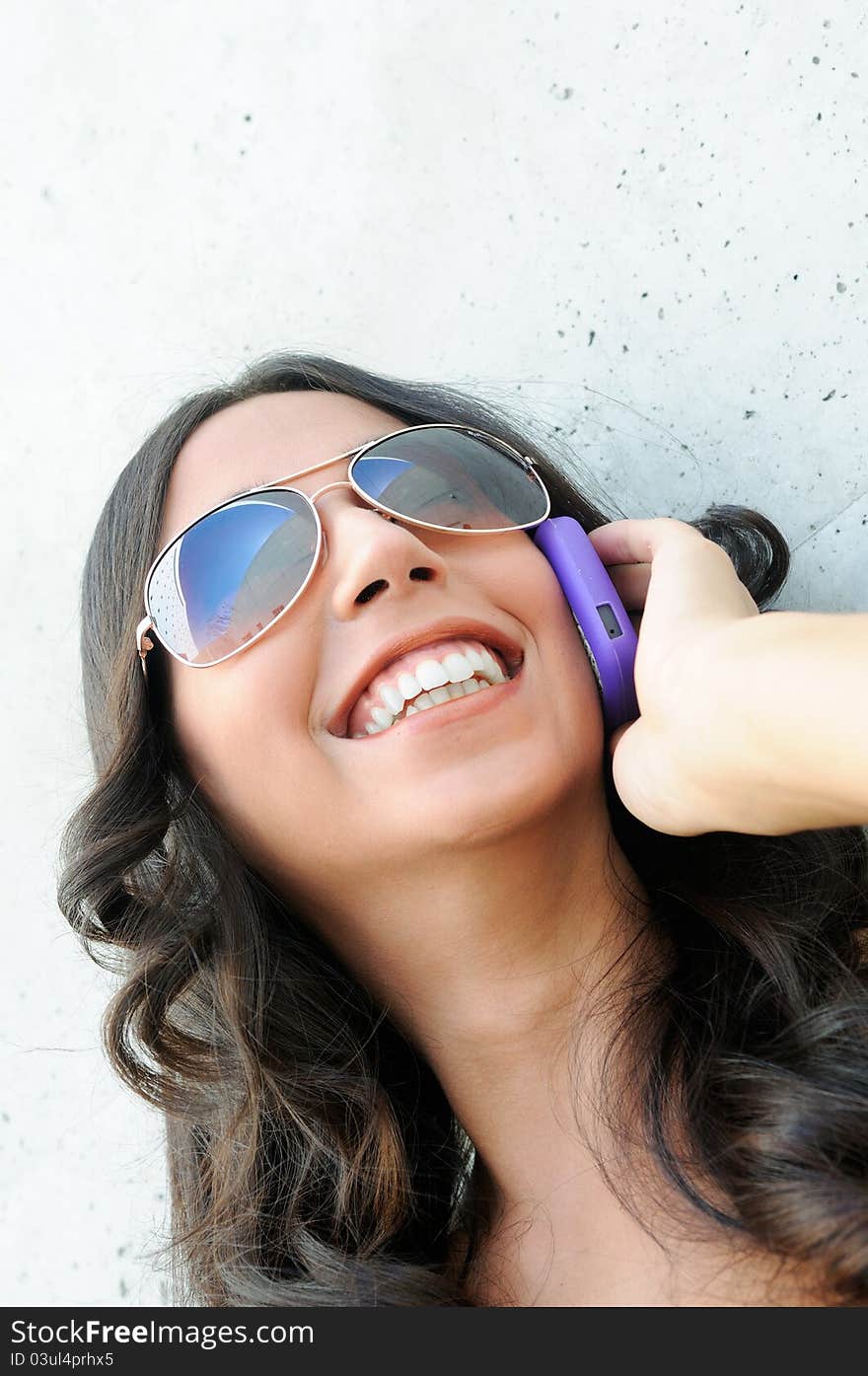 Young beautiful woman talking on phone