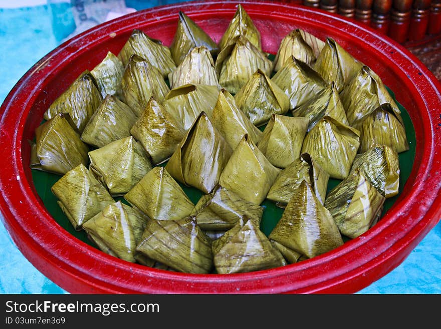 Thai dessert made ​​of rice wrapped in banana leaves. Thai dessert made ​​of rice wrapped in banana leaves.