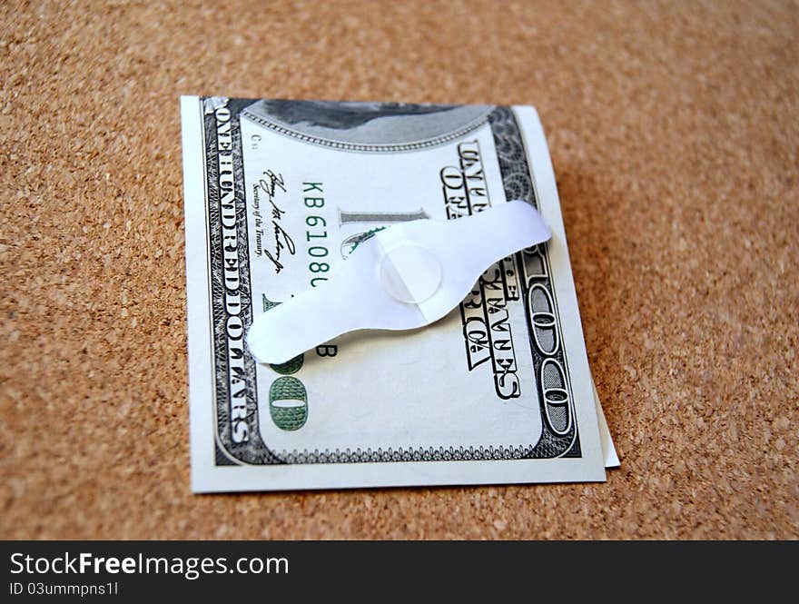 American dollar bill and a band aid on a table