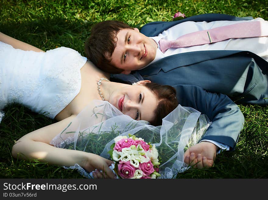 Happy bride and groom on grass