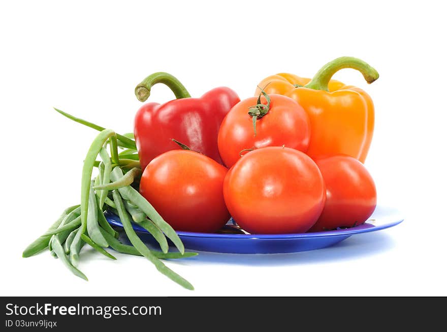 Vegetbles on blue plate, on a white background. Vegetbles on blue plate, on a white background