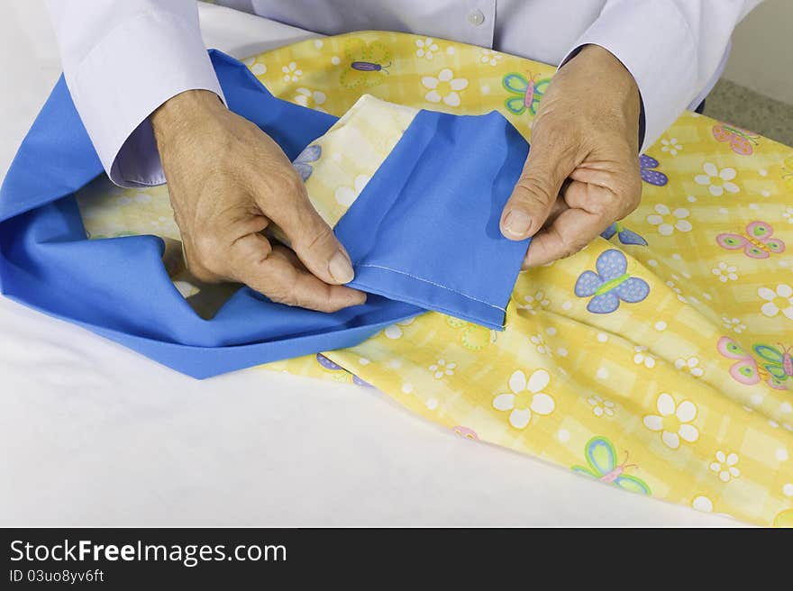 A woman turns pillow case right side out and shows finished seams, no raw edges. A woman turns pillow case right side out and shows finished seams, no raw edges.