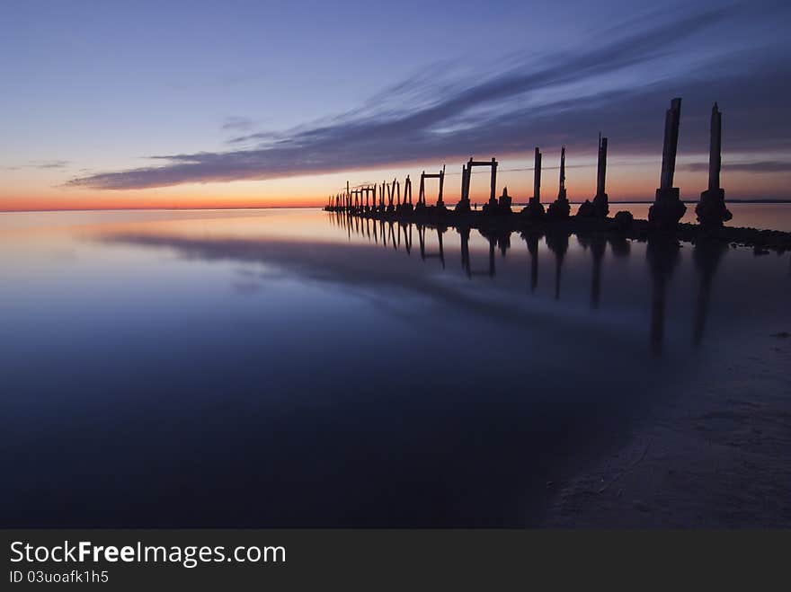 Long exposure of an old broken down pier at sunset. Long exposure of an old broken down pier at sunset.