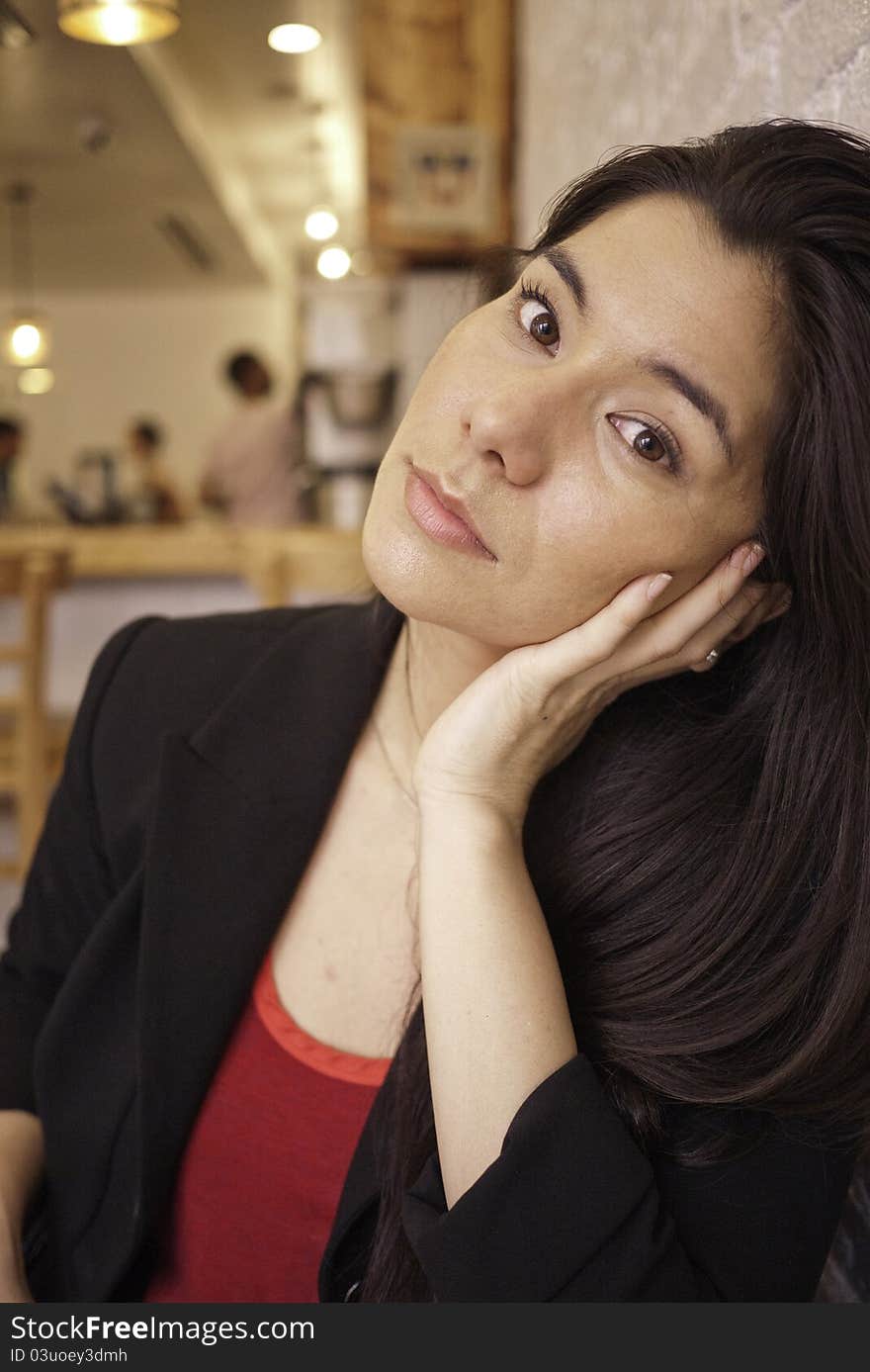 Pretty brunette with red shirt and dark coat