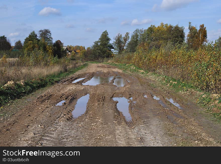 Dirty country road at village outskirts, Russia