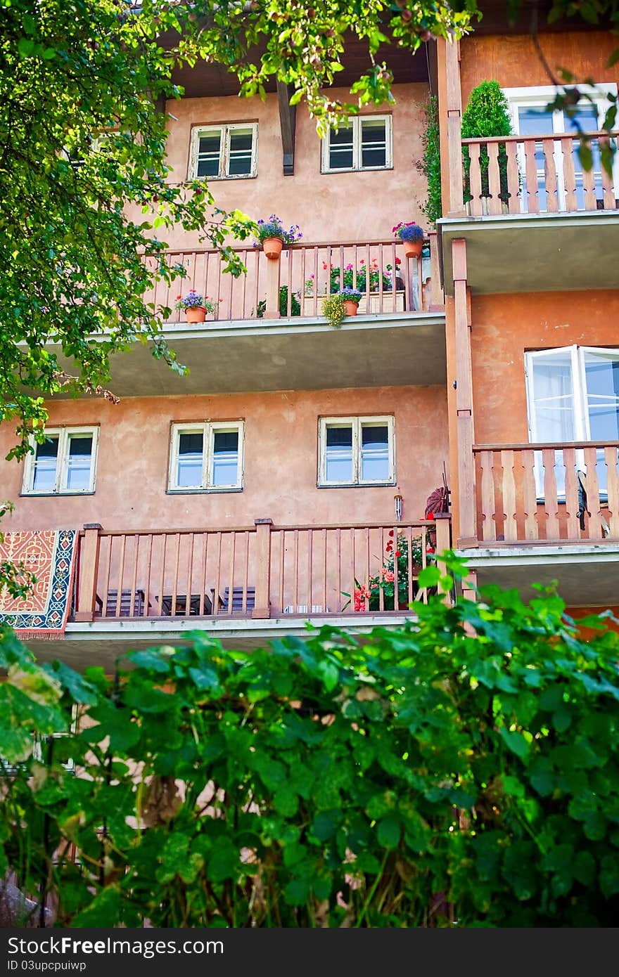 Facade of old building in Old town of Warsaw, with comfortable balconies and flowers in pots. Facade of old building in Old town of Warsaw, with comfortable balconies and flowers in pots