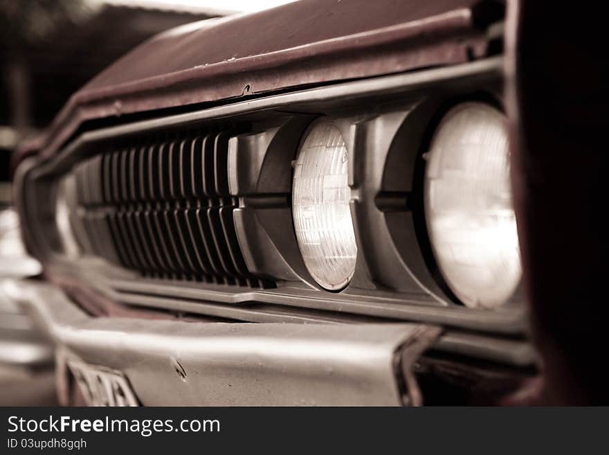 Old car headlights in sepia tone