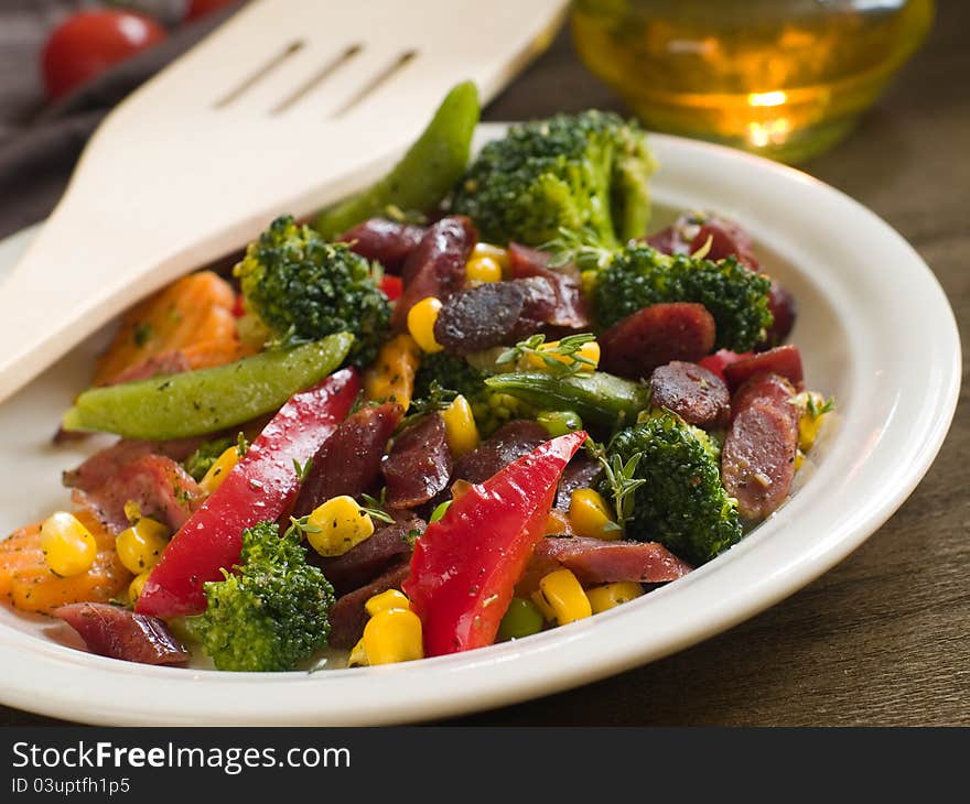 Various roasted vegetable salad with sausage, selective focus