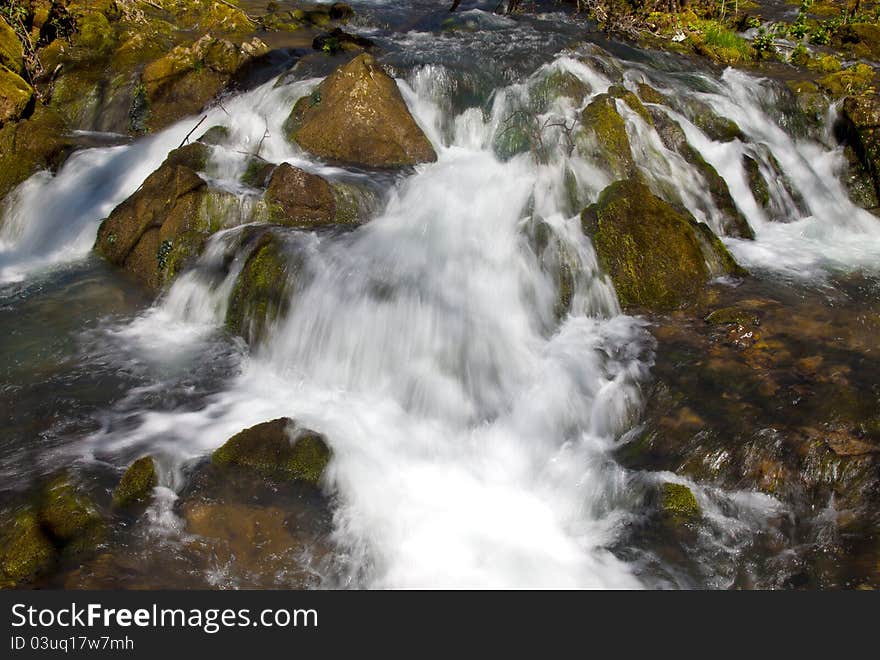 Close-up of river rapid, water splashing down the stones. Close-up of river rapid, water splashing down the stones