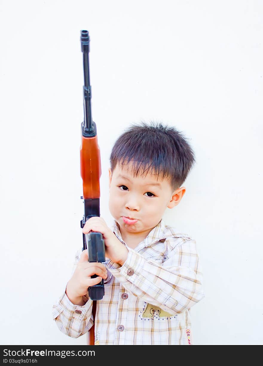 Lonely asian boy with gun in his arm