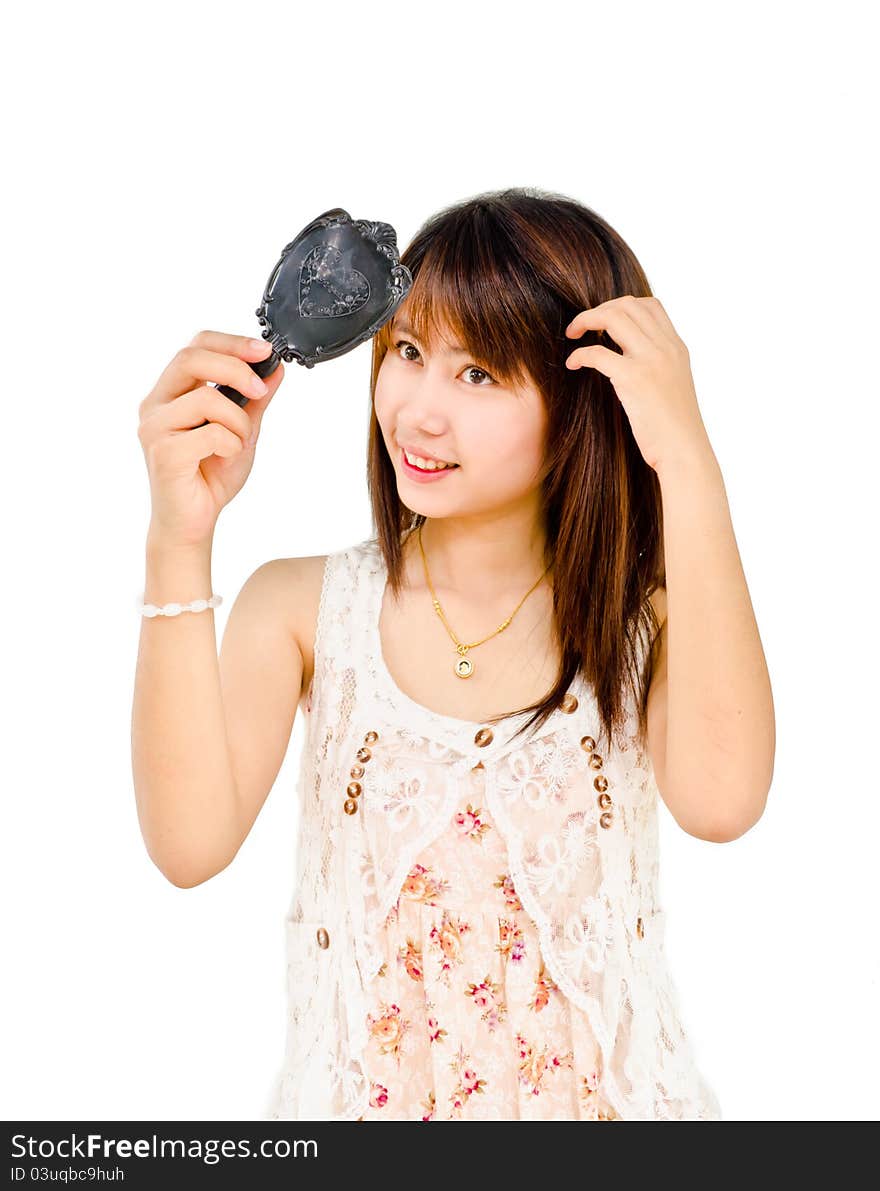 Happy cute girl looking at mirror on white background