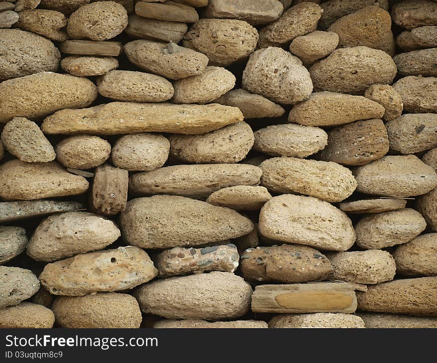 Wall background made of sea washed round stones. Wall background made of sea washed round stones