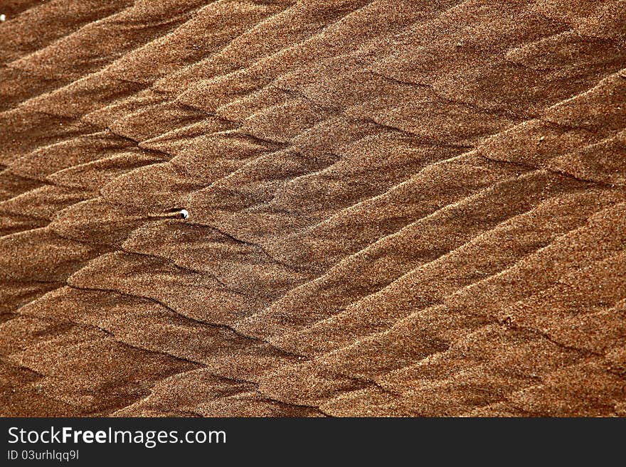 North Sea beach with flowing pattern in the sand. North Sea beach with flowing pattern in the sand