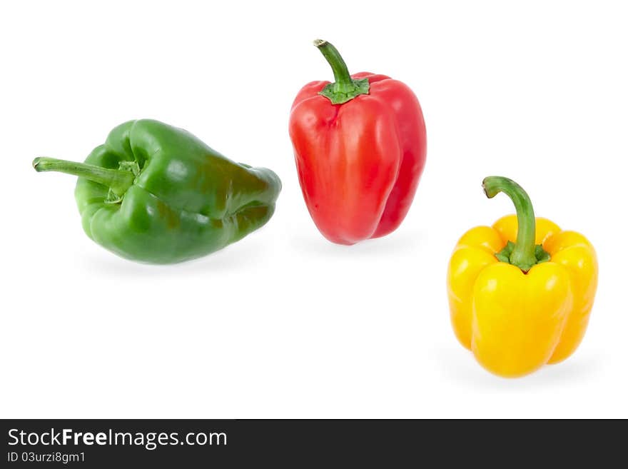 Yellow, green and red peppers on a white background