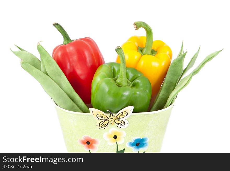 Green beans with yellow, green and red peppers on a white background