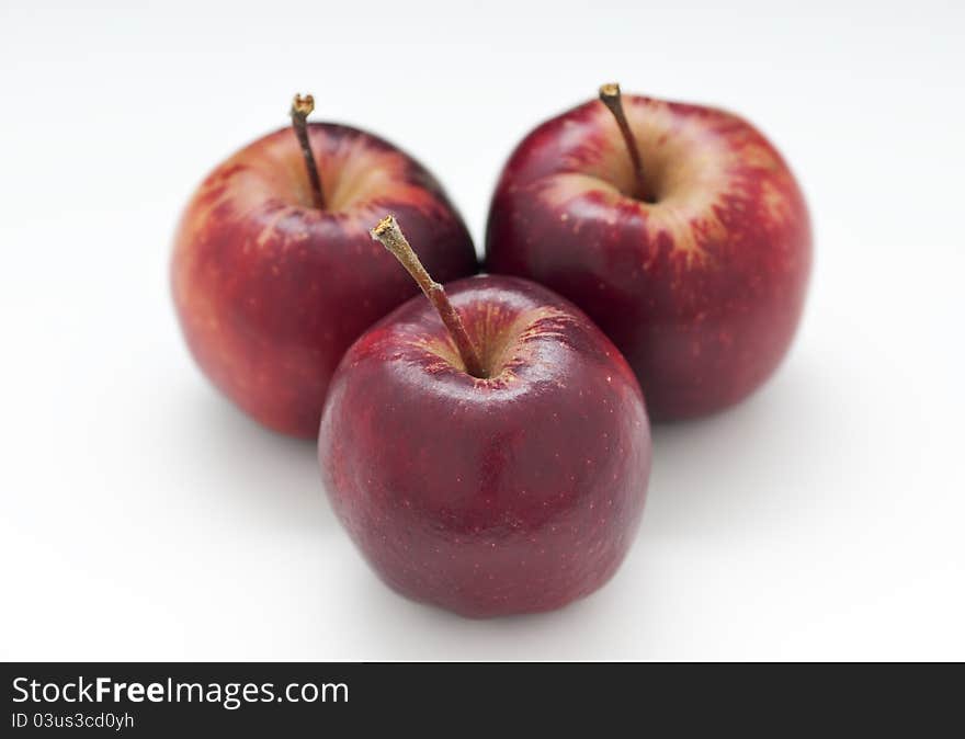 Three red heirloom apples with white background. Three red heirloom apples with white background