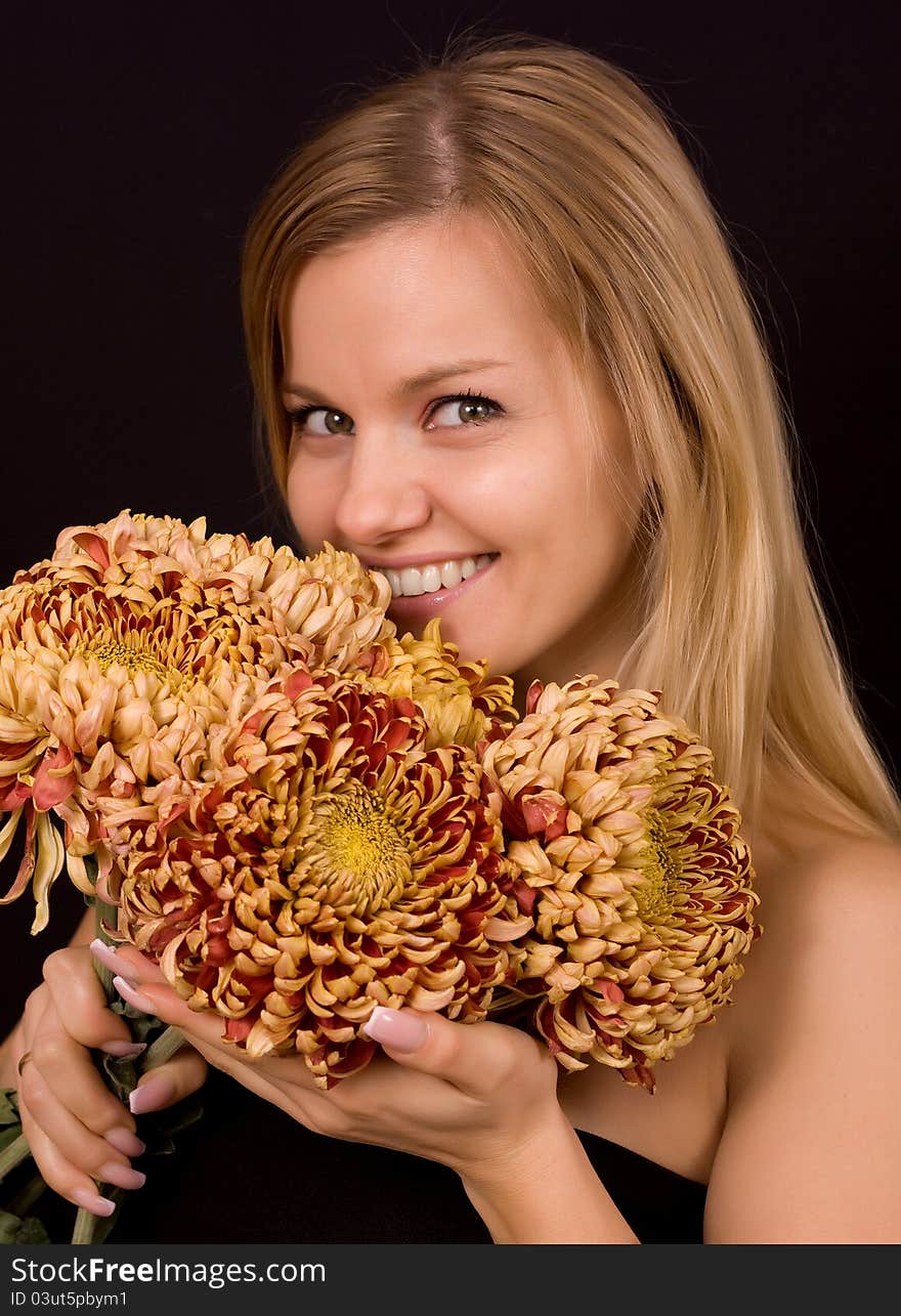 Romantic image of a young woman with yellow chrysanthemums.