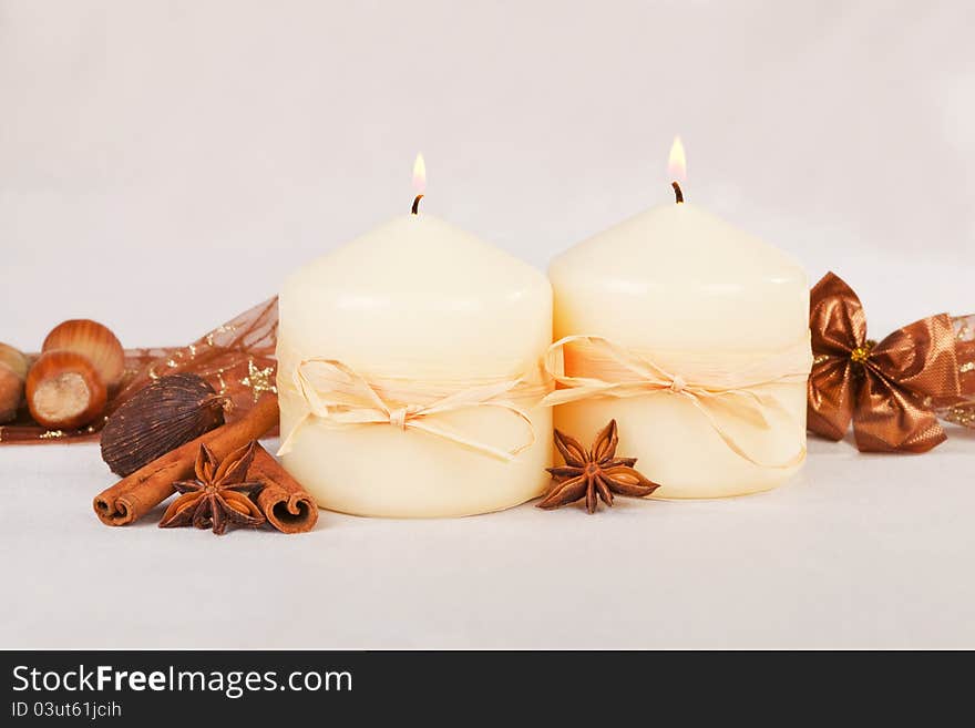 Beautiful traditional christmas still life with burning candles, almond, nuts. ribbon and brown decoration. Beautiful traditional christmas still life with burning candles, almond, nuts. ribbon and brown decoration.