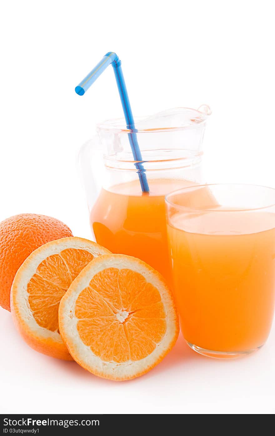 Orange juice in jug and glass with pipe over white