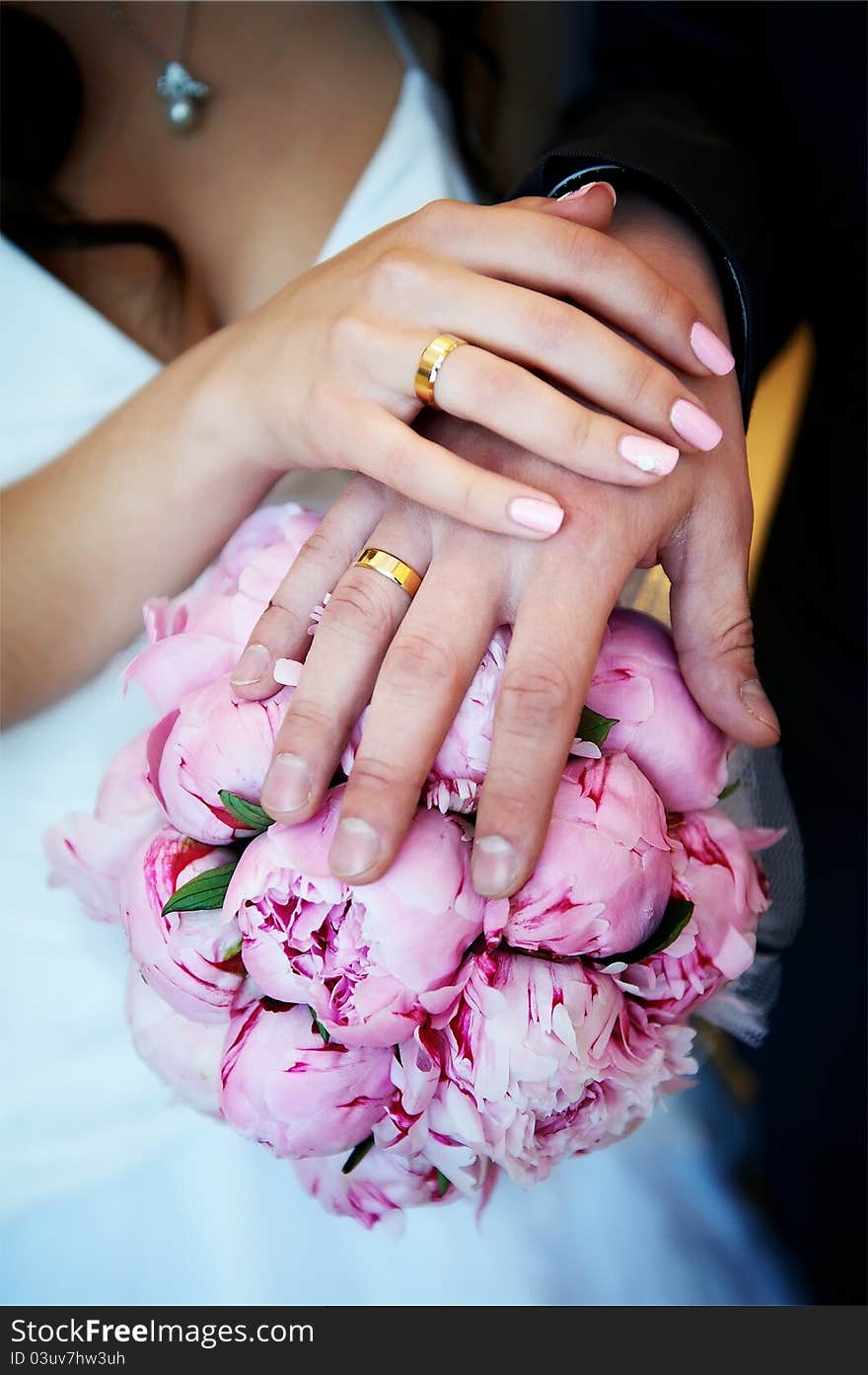 Hands with wedding gold rings happy newlyweds