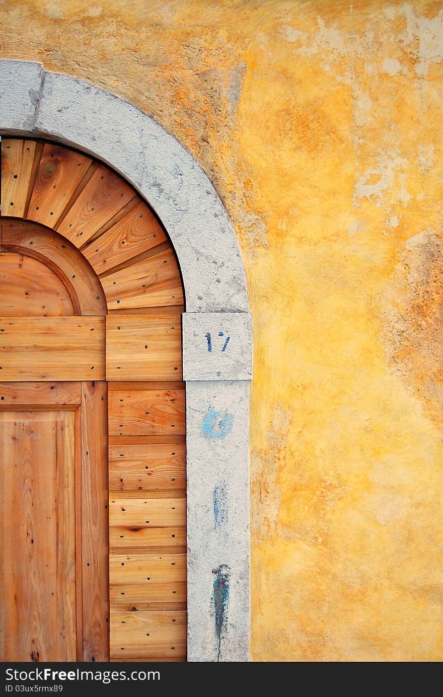 Ancient door with yellow wall