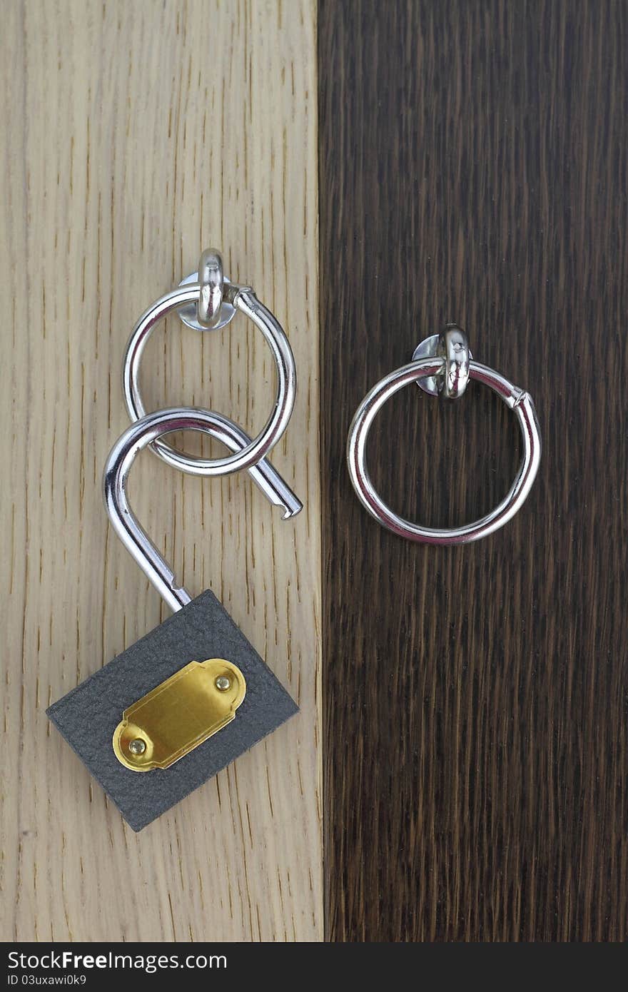 Opened padlock on wooden door