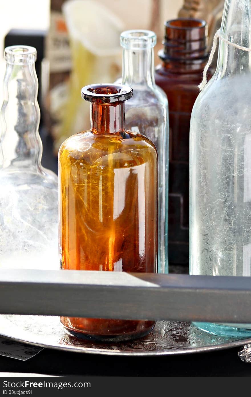 Assortment of clear and brown glass bottles. Assortment of clear and brown glass bottles