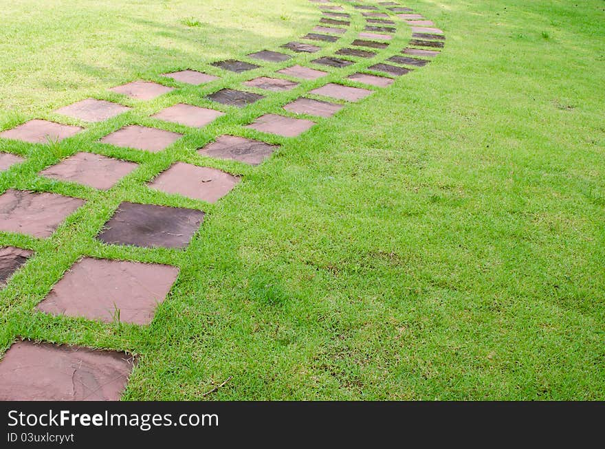 Stone walkway line on grass in the garden. Stone walkway line on grass in the garden