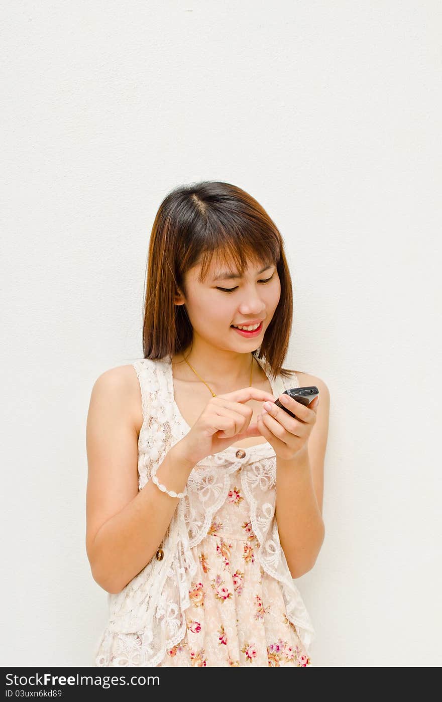 Happy asian girl smile and touching her cell phone. Happy asian girl smile and touching her cell phone