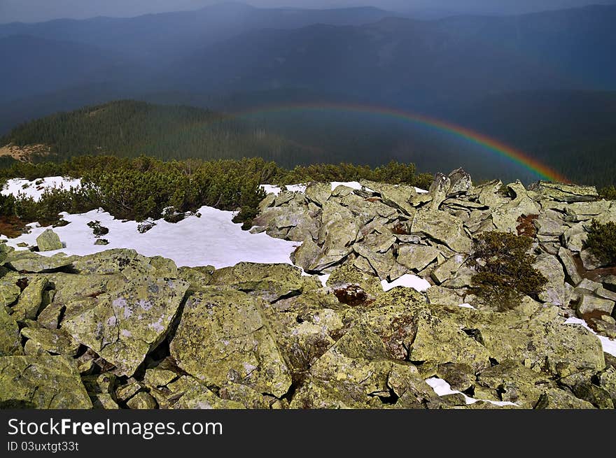 Multi-colored rainbow high in the mountains. Multi-colored rainbow high in the mountains