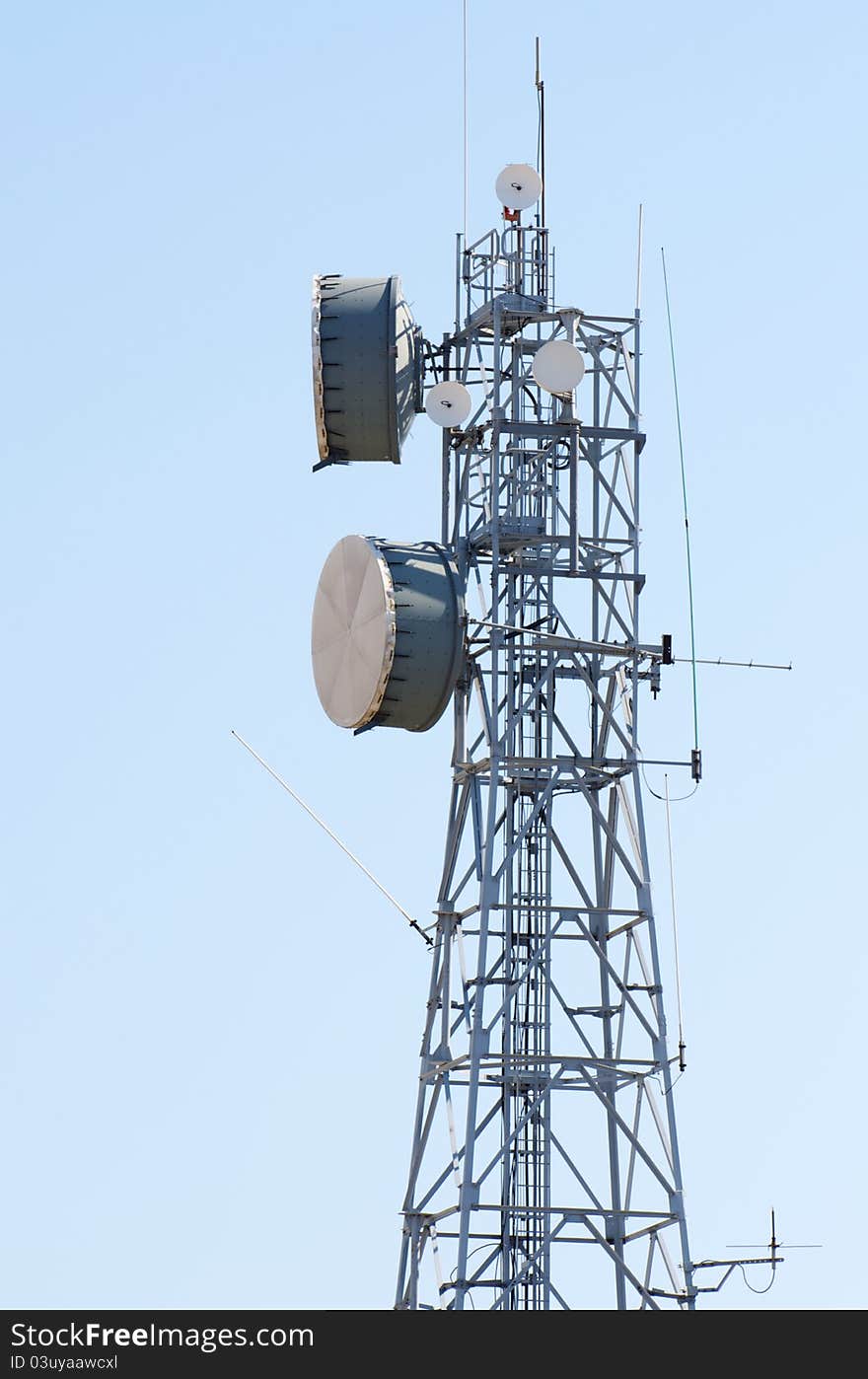 Telecommunications tower, painted in a day of clear blue sky