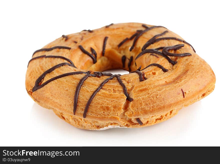 Cake in the shape of a ring of cream on a white background. Cake in the shape of a ring of cream on a white background.