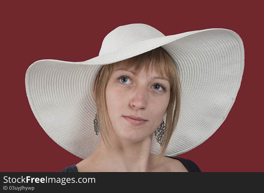 Pretty girl with white hat isolated on red background. Pretty girl with white hat isolated on red background