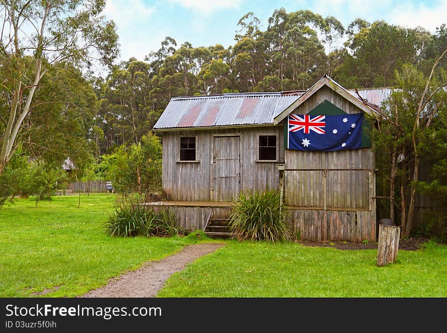 A rustic old wooden cabin with Australian flag in Tasmania. A rustic old wooden cabin with Australian flag in Tasmania.