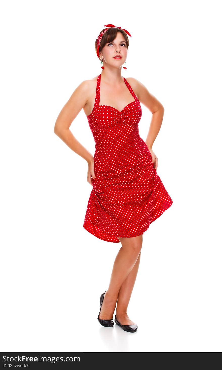 Young girl in a red dress standing on the floor, isolated white background. Young girl in a red dress standing on the floor, isolated white background.