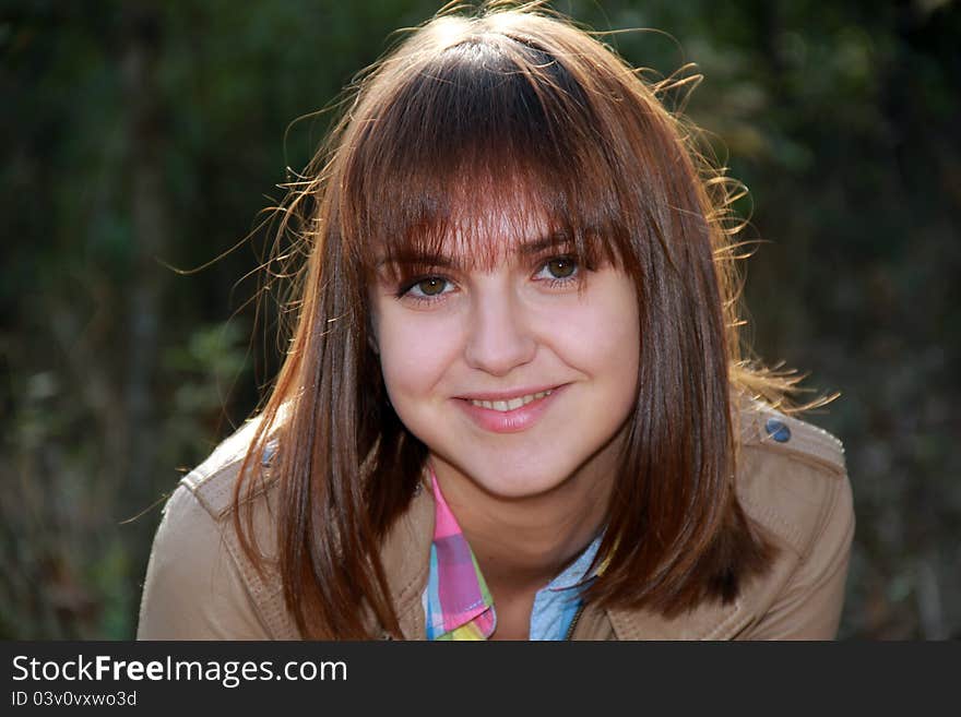 Portrait of a beautiful girl on a background of foliage. Portrait of a beautiful girl on a background of foliage