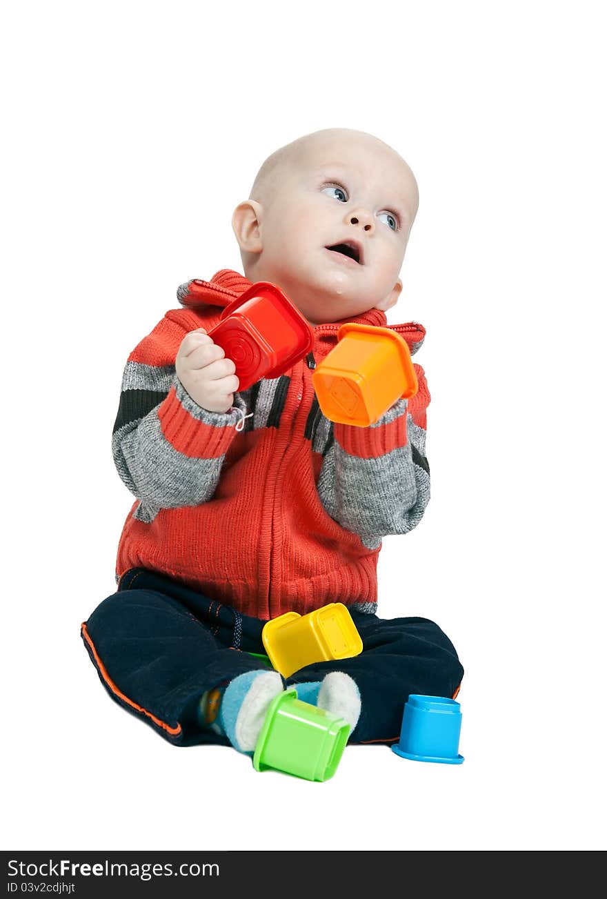 Little boy with a plastic pyramid in the studio on a white background