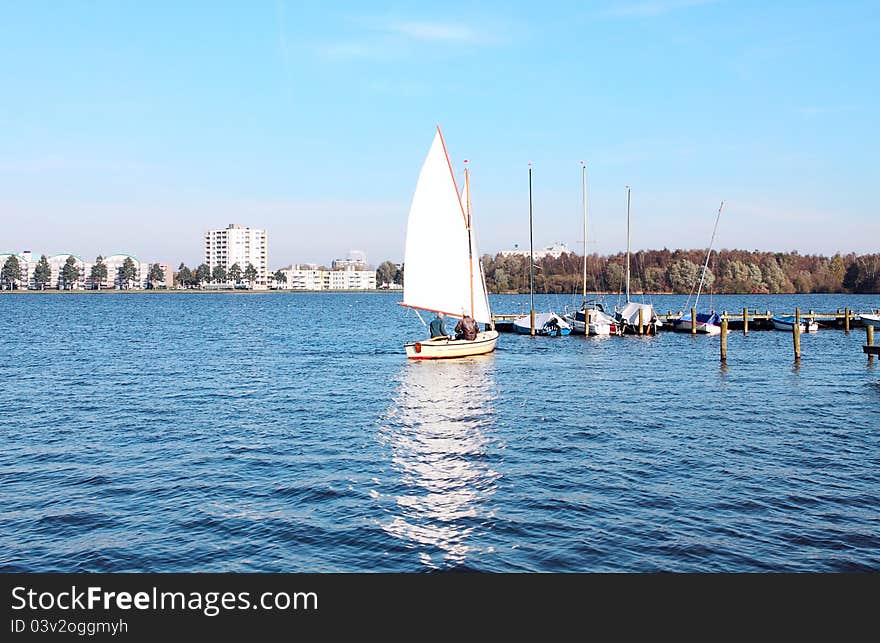 White yacht on the big blue lake. White yacht on the big blue lake